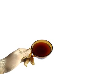 Hand with medical latex glove holding a cup of coffee on white background