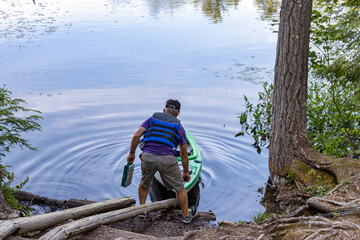 man launching kayak