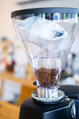 Coffee beans in coffee maker at cafe