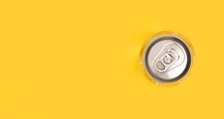 Metal can lid of water on yellow background. Monochrome image. Creative idea, new package of clear...