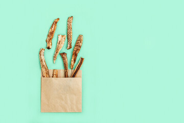 Healthy snack. Nature Organic Dried Fruit Banana in paper package as fast food potatoes fri. Diet food instead of fat and harmful.