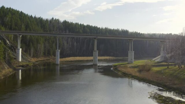 Flying over the water under a road bridge