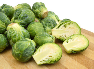 freshly brussel sprouts and some whole ones on wooden board