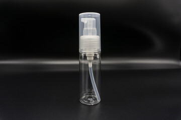 Spray bottle, empty pump clear plastic container cosmetic soap and mineral shampoo. Antiseptic bottle isolated on gray background.Empty pump clear plastic container. 