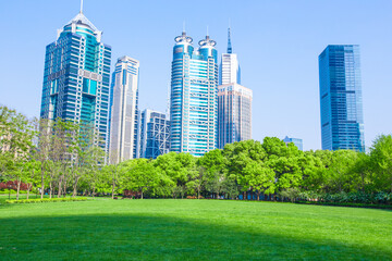 Naklejka premium Central Park in Lujiazui, a big lawn in front of the modern skyscrapers.
