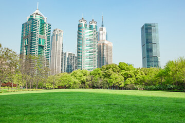 Obraz premium Central Park in Lujiazui, a big lawn in front of the modern skyscrapers.