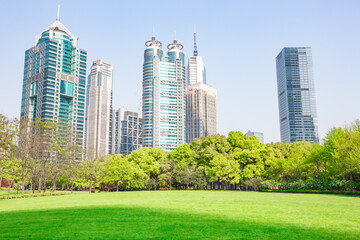Obraz premium Central Park in Lujiazui, a big lawn in front of the modern skyscrapers.