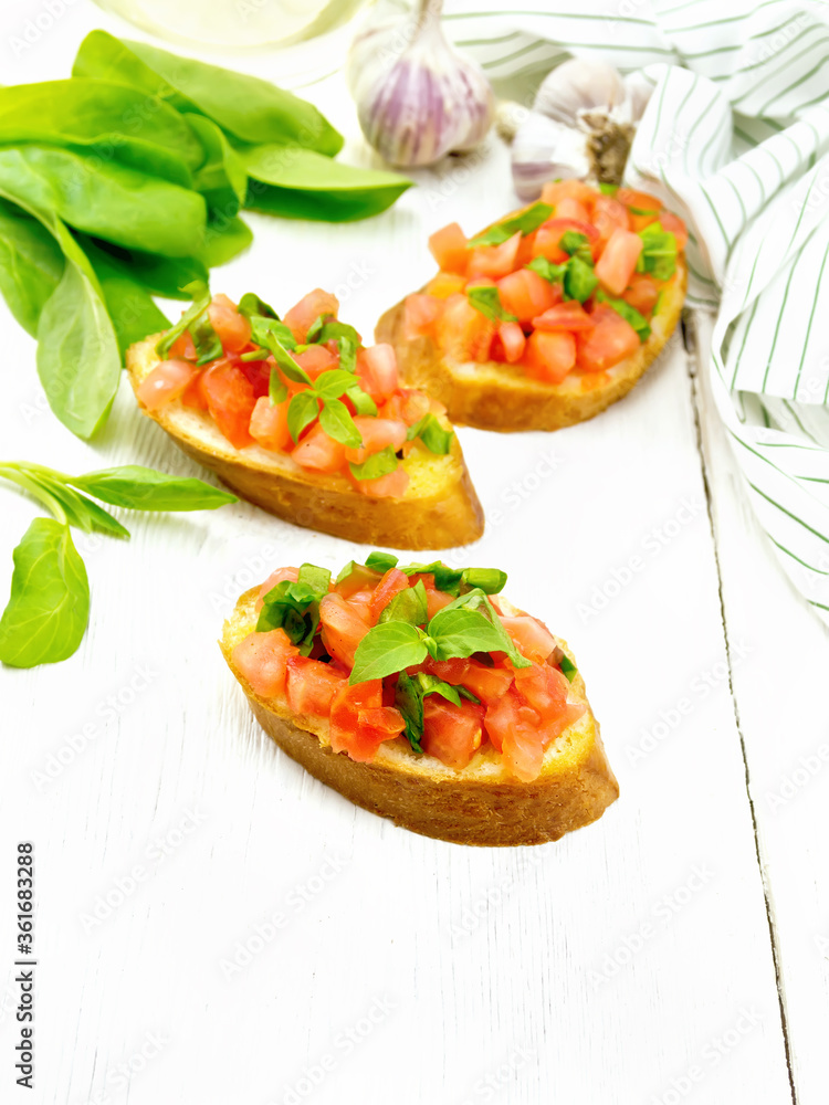 Poster bruschetta with tomato and spinach on light table