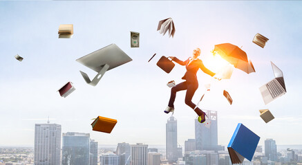 Young businesswoman walking with umbrella