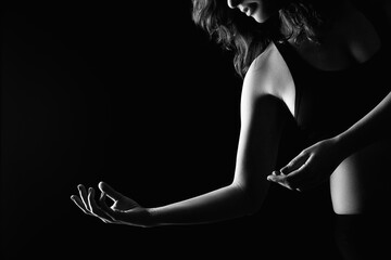 Spiritual dance. Harmony balance. Sensual woman silhouette graceful movements isolated on black copy space.