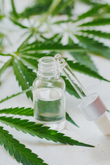Cosmetics with cannabis oil on a white background. The concept of luxurious skin care.