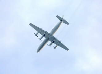 Turboprop aircraft flying through the sky at low altitude