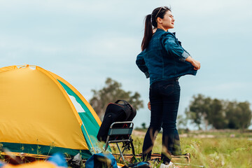 A group of friends traveling and camping near lake and mountain back.