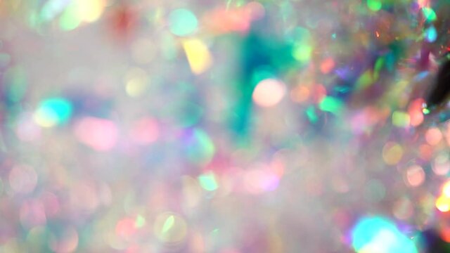 Holographic iridescent spectrum color foil. Hologram Background of abstract glitter foil texture with multiple colors. Blue pink purple neon pastel gradient of real surface