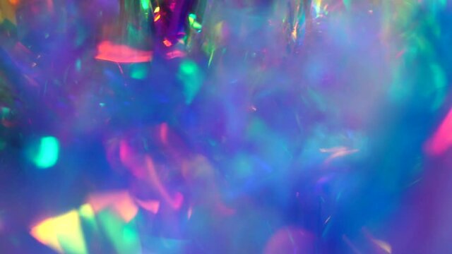 Holographic iridescent abstract background. Shiny holiday texture with rainbow colors. Neon pastel gradient hologram