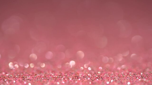 Pink shiny glitter sparkle texture macro. Beautiful bokeh holiday abstract background