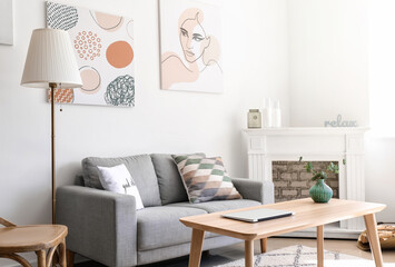 Interior of modern room with table, fireplace and sofa