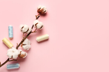 Cotton flowers and threads on color background