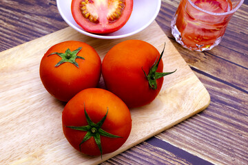 Fresh tomatoes on a wooden table