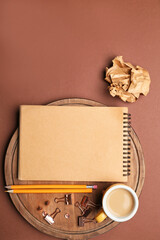 Office supplies with cup of coffee on color background