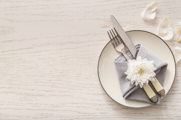 Simple table setting on white wooden background