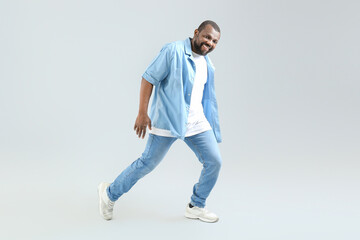 Fototapeta na wymiar Male African-American hip-hop dancer on light background