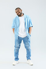 Fototapeta premium Male African-American hip-hop dancer on light background