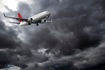 Commercial passenger plane with landing gear down flying through dramatic storm clouds
