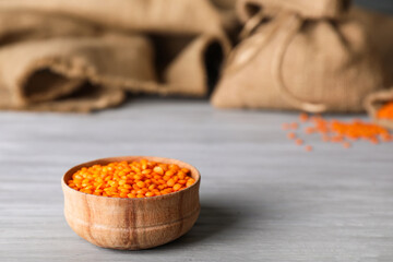 Bowl with red lentils on table