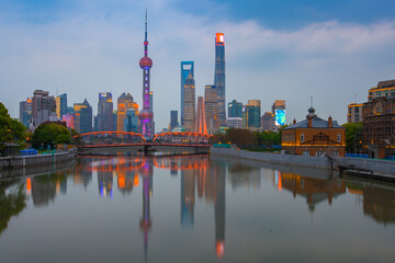 Fototapeta na wymiar Sunset view of Waibaidu Bridge and Lujiazui, the skyline and landmark in Shanghai, China, with reflection in front.