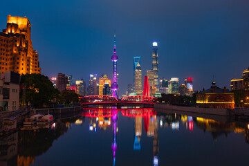 Fototapeta na wymiar Night view of Waibaidu Bridge and Lujiazui, the skyline and landmark in Shanghai, China, with reflection in front.