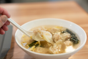 Wonton soup, Chinese traditional food with boiled meat filled wonton and seaweed soup.