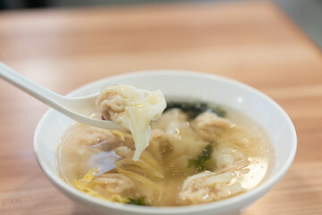 Wonton soup, Chinese traditional food with boiled meat filled wonton and seaweed soup.