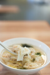 Wonton soup, Chinese traditional food with boiled meat filled wonton and seaweed soup.