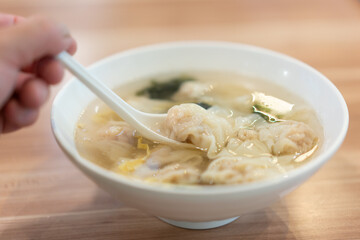 Wonton soup, Chinese traditional food with boiled meat filled wonton and seaweed soup.
