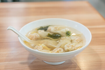 Wonton soup, Chinese traditional food with boiled meat filled wonton and seaweed soup.