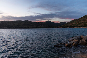 sunset seascape with stones in water in southern Sardinia