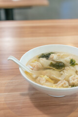 Wonton soup, Chinese traditional food with boiled meat filled wonton and seaweed soup.