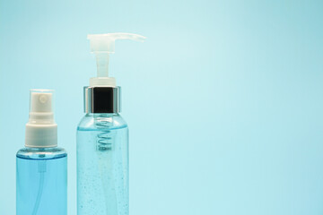 Alcohol spray 70% and hand sanitizer on a blue background for cleaning and disinfecting for good hygiene preventing coronavirus (COVID-19) or bacteria.