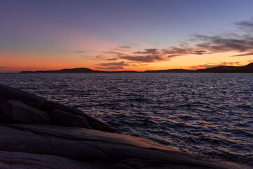 sunset seascape with stones in water in southern Sardinia