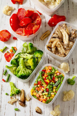 Frozen vegetables. Stocks of food for the winter. Container with frozen vegetables and mushrooms.