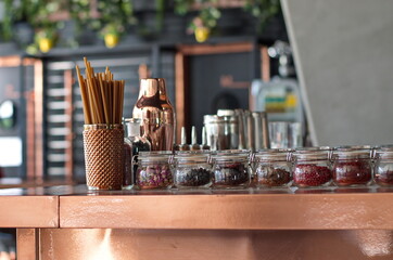 Herbs and seeds in glass jars on bar desk