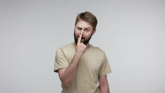 You lie to me! Bearded man suspecting falsehood, touching nose doing liar gesture and pointing at camera, angry about deception, distrustful communication. studio shot isolated on gray background