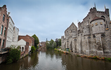 Fototapeta na wymiar View of Gravensteen castle and Ghent canal. Architecture and landmark of Ghent Belgium