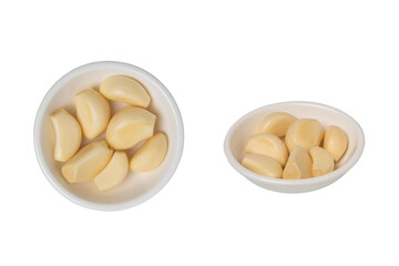 Bowl of peeled garlic isolated on white background