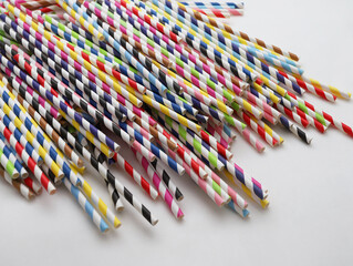 Drinking colorful paper straws for cocktails on white background.