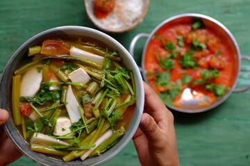Vietnamese meal for lunch, vegetarian homemade food, tofu ball cook with tomato sauce, vegetable soup, rice bowl