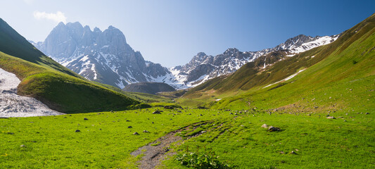 Hiking trail in Juta valley with Chauki mountain background in summer season, Caucasus mountains range in Georgia. Panoramic banner portion © skazzjy