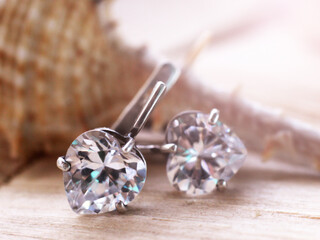 Silver diamond earrings so close, nature background