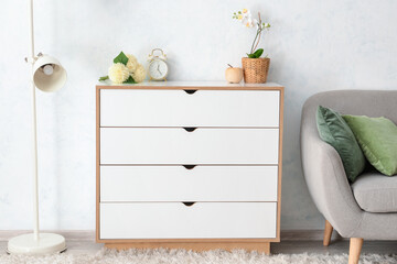 Interior of room with modern chest of drawers
